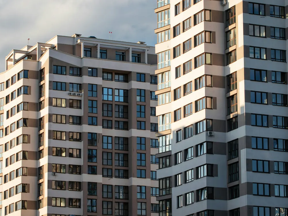 Duas torres residenciais com fachada clara e janelas em fileiras